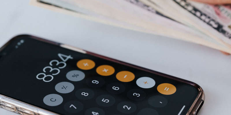 Calculator and money, representing creditor attorney services.